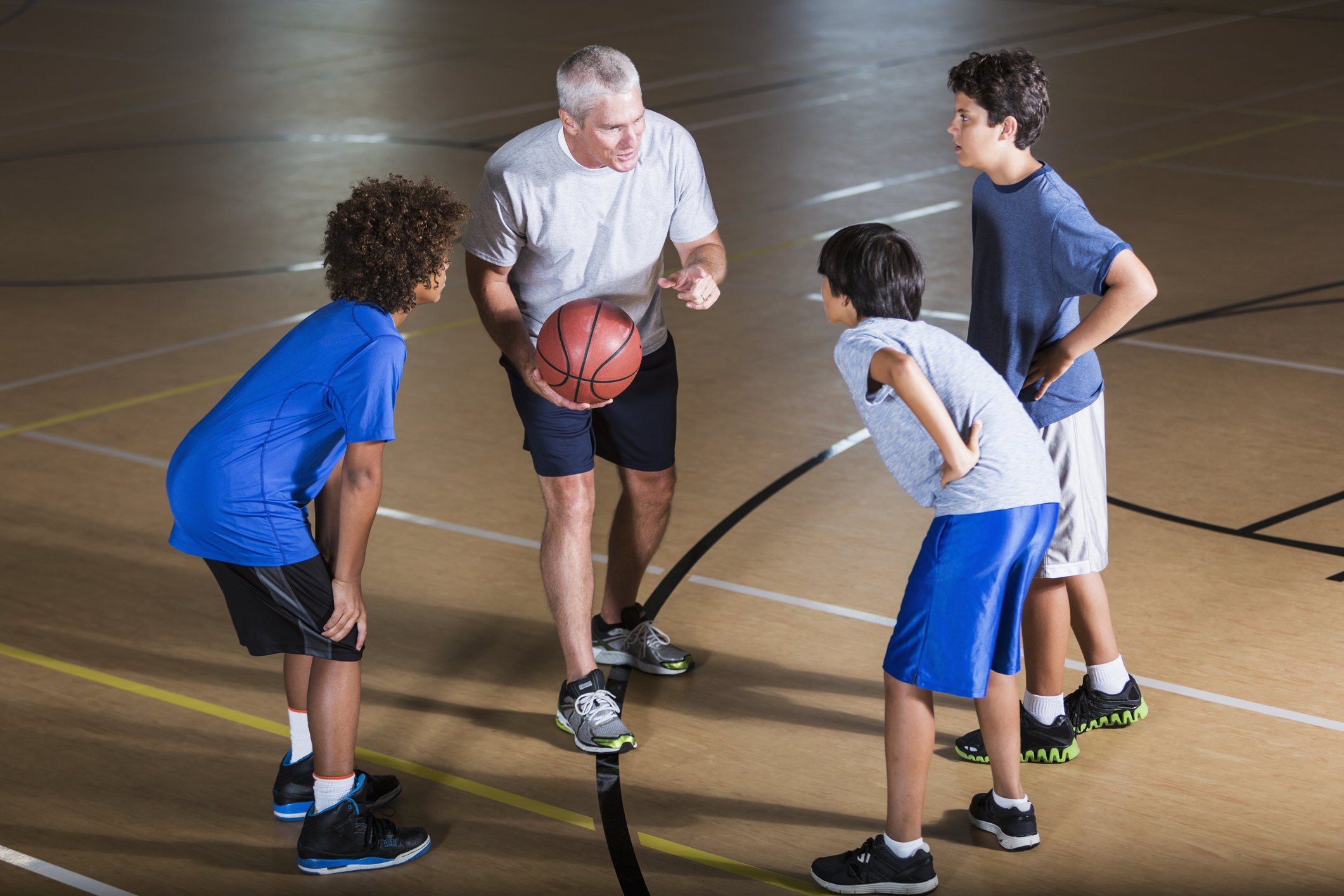 Boys with basketball coach