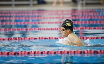 Young boy swimming in a race at AUT Millennium