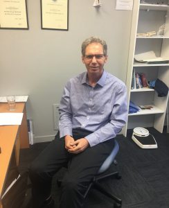 Dr Simon Mayhew in his clinic office
